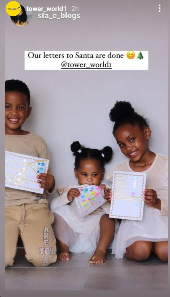 Image of kids holding their Christmas letters decorated with TOWER gold star stickers and colour faces stickers by sta_c_blogs on Instagram.