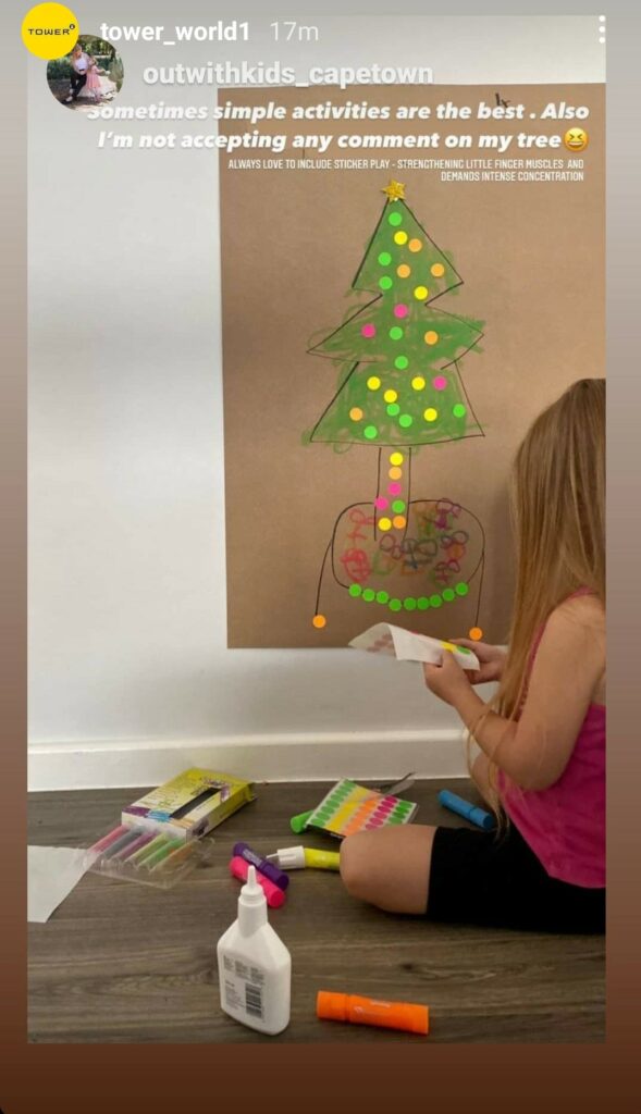 Image of a child decorating her Christmas tree drawing with TOWER mixed neon colour code stickers by outwithkids_capetown on Instagram.